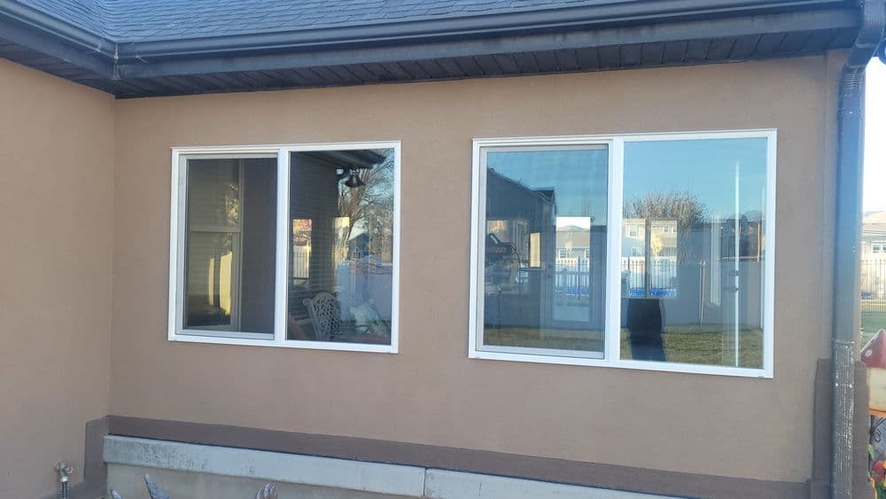 Modern home with large, clear vinyl windows showcasing outdoor view and sunny day.